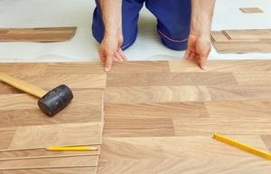 man laying hardwood floor